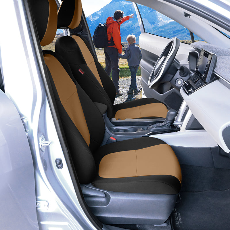 Tan and black NeoSupreme car seat covers on the front seats of a silver vehicle. A father and a son are visible outside looking at mountains in the background.