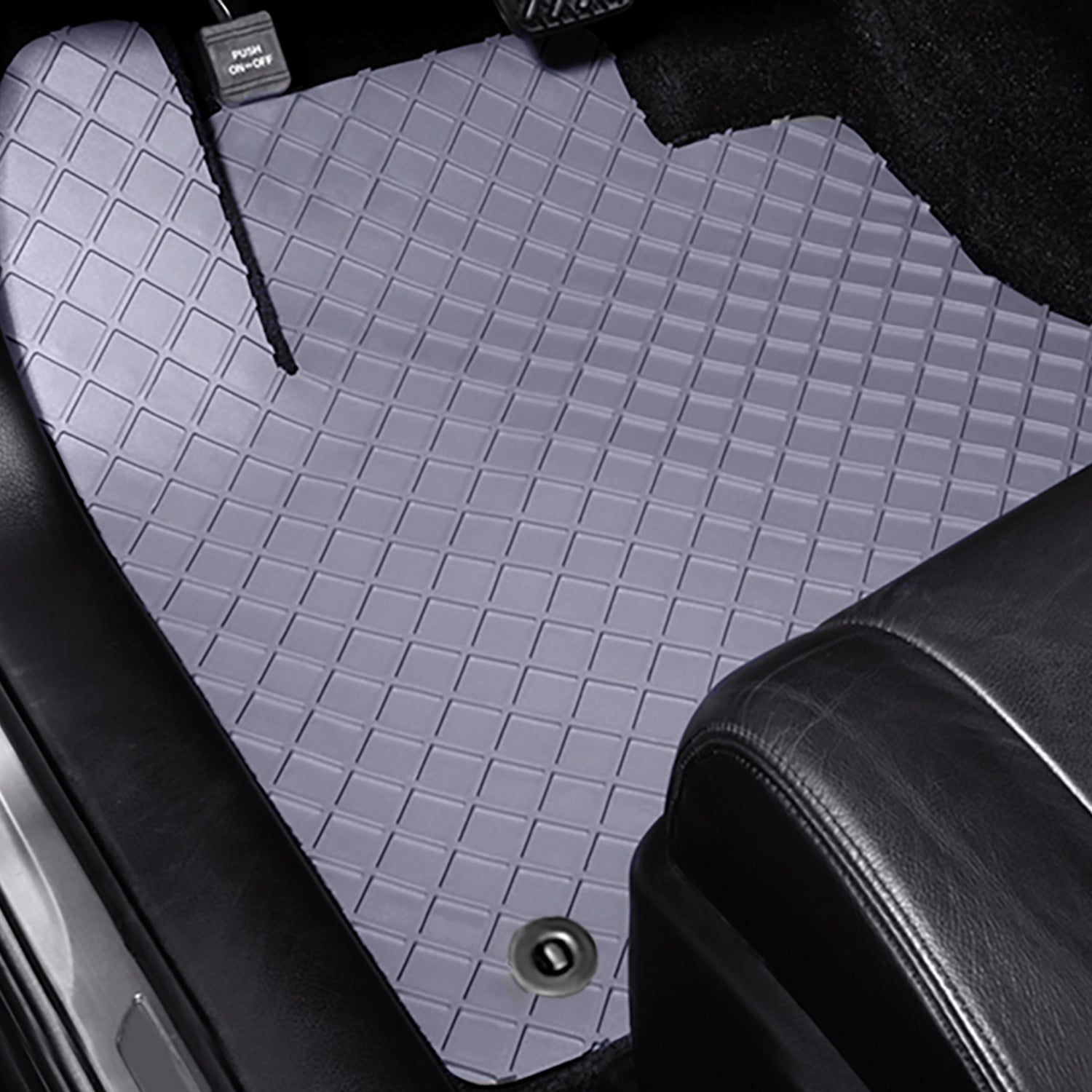 Gray FlexoMat floor mat in a vehicle with black leather seats.