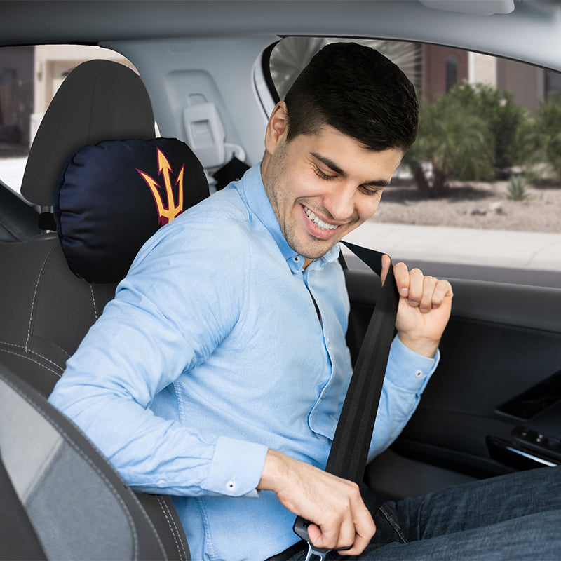 Guy fastening seat belt with ASU Travel Pillow in car