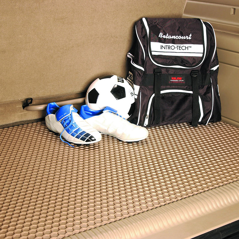 Tan HexoMat cargo mat with backpack, soccer shoes, and ball.