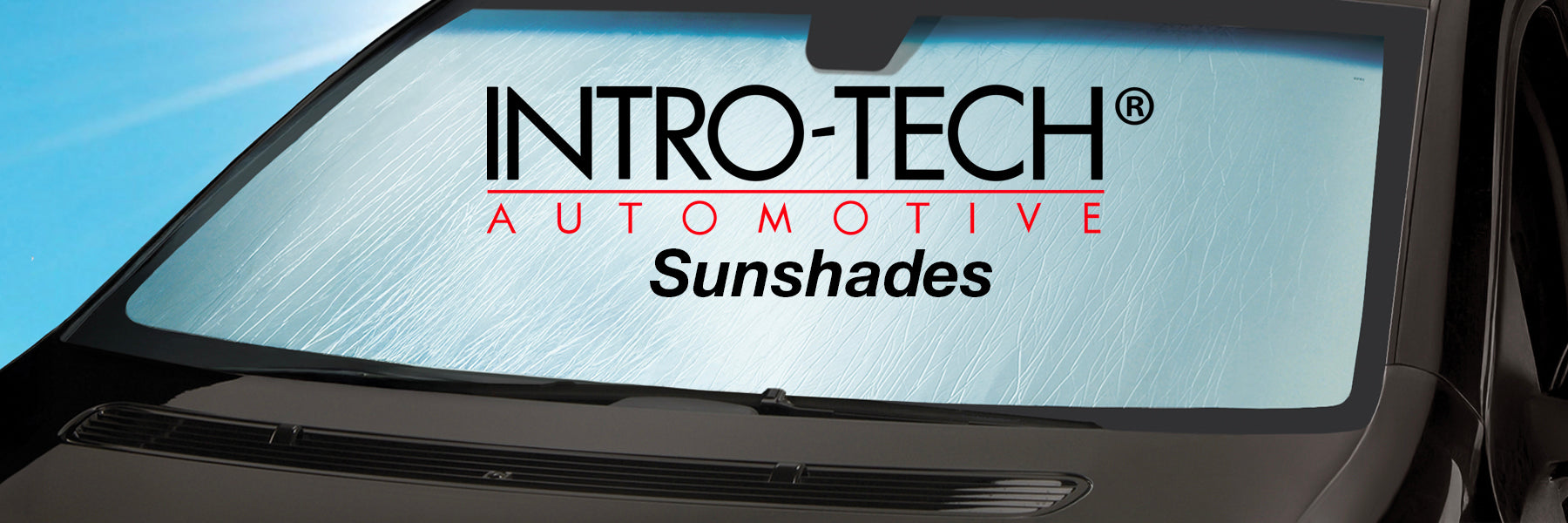 Intro-Tech Automotive sunshade installed, showing the brand logo