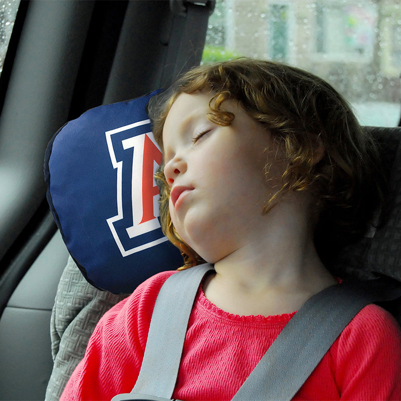 Little girl in car with University of Arizona Travel Pillow